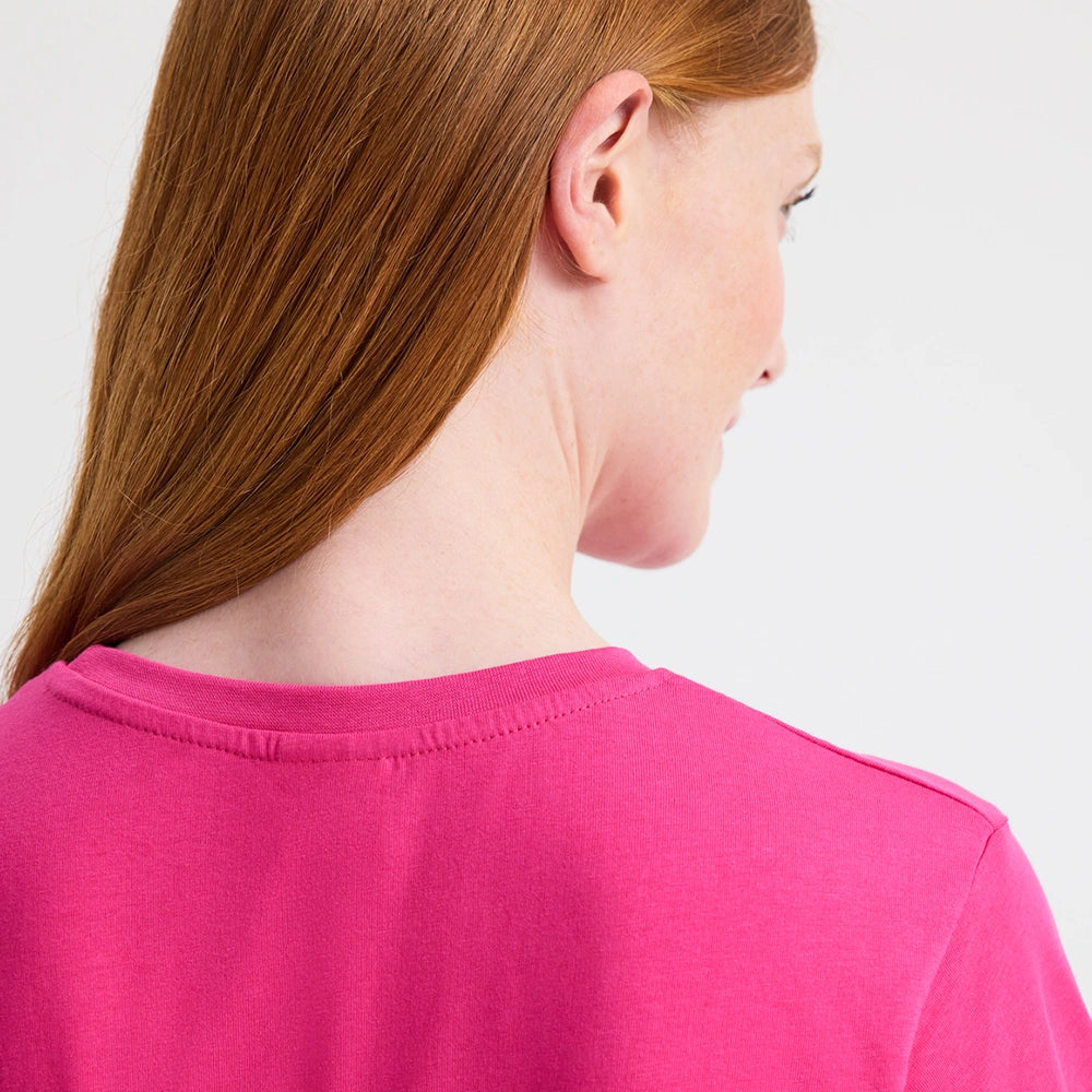 close up back view of woman wearing hot pink tee