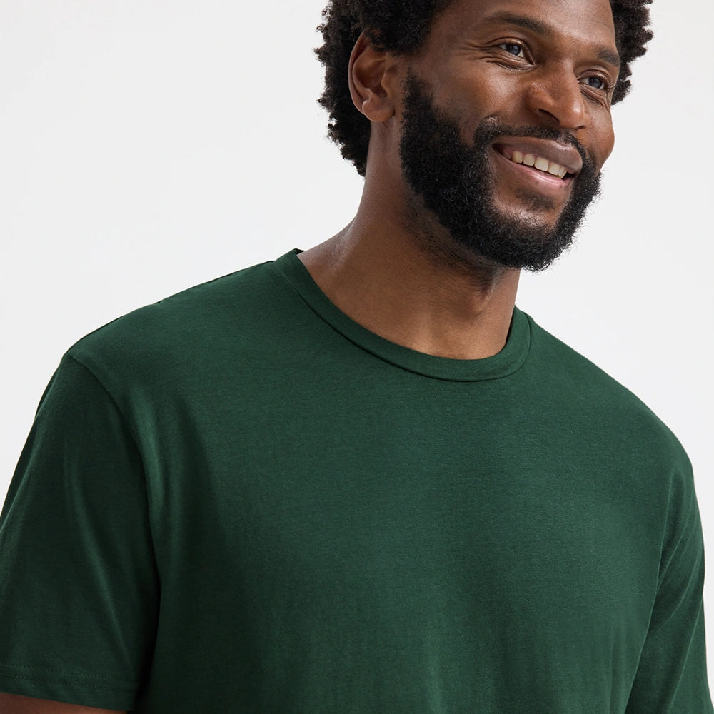 close up front view of model wearing Uneek Olympic T-shirt UC320 bottle