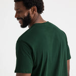 close up back view of model wearing Uneek Olympic T-shirt UC320 bottle