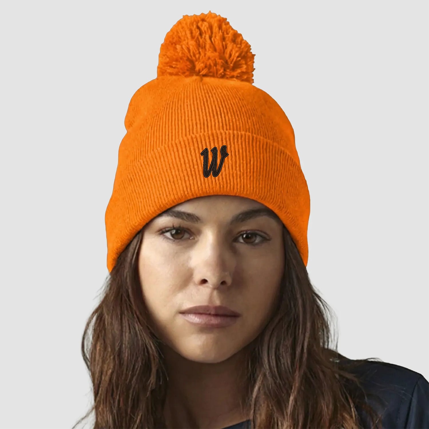Model wearing the Winsford ASC Cuffed Bobble Beanie (Orange) BC426