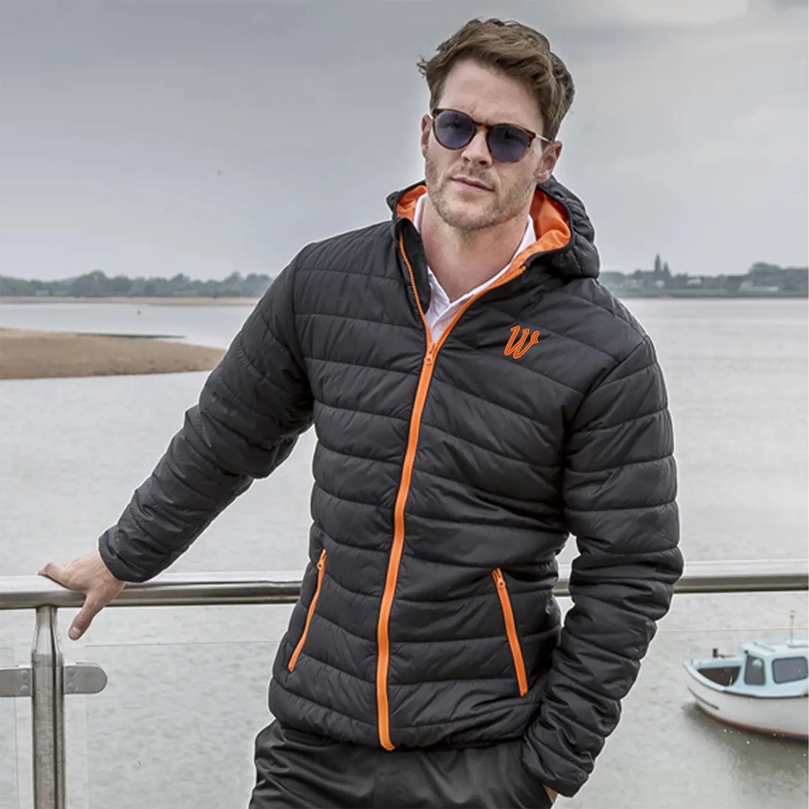 Model wearing the Winsford ASC Padded Jacket – Adults RS233M in Black / Orange