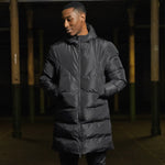 Model wearing the Surridge Sport Active Long Padded Coat WL005 in Black.