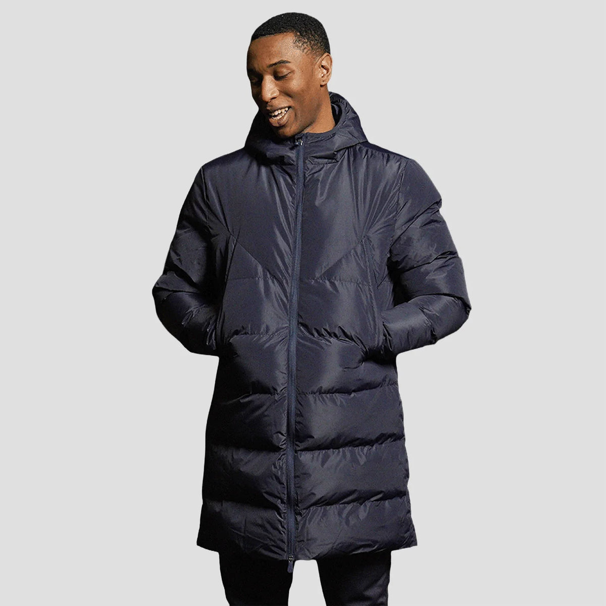 Model wearing the Stuart Surridge Active Long Padded Coat WL005 in Navy.