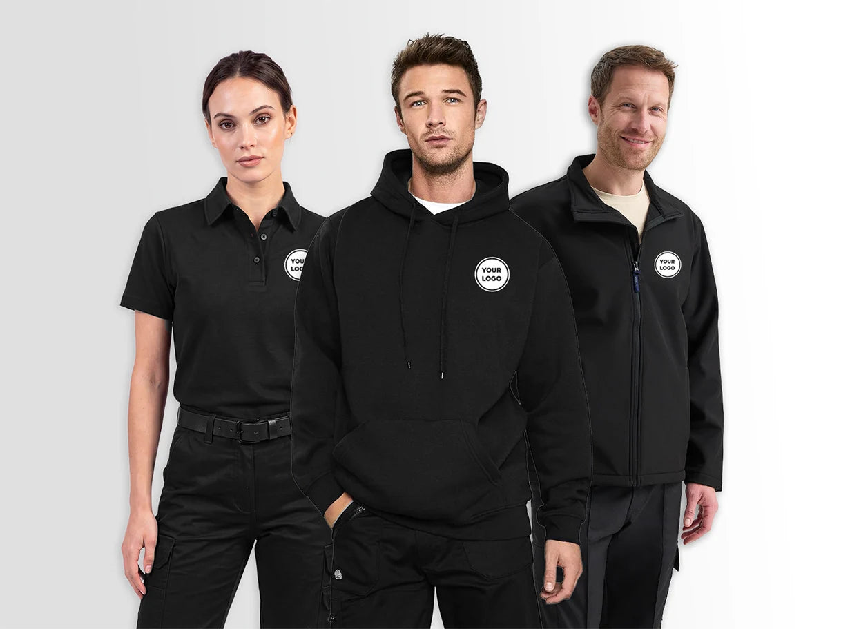Three models wearing black branded uniform apparel, including a polo shirt, hoodie, and zip-up jacket, each with a circular white-and-black logo patch on the left chest, photographed against a light grey studio background.