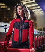 Female model wearing the Regatta E-Volve Unisex Two Layer Soft Shell Bodywarmer in Classic Red / Black